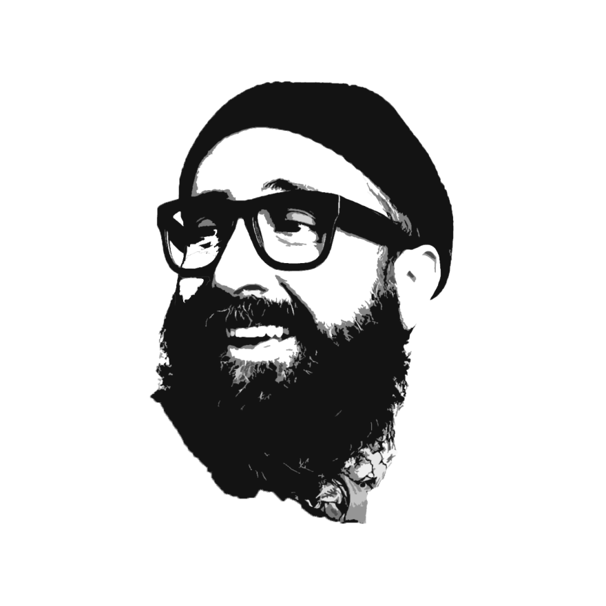Man with a beard wearing a beanie and thick-rimmed glasses