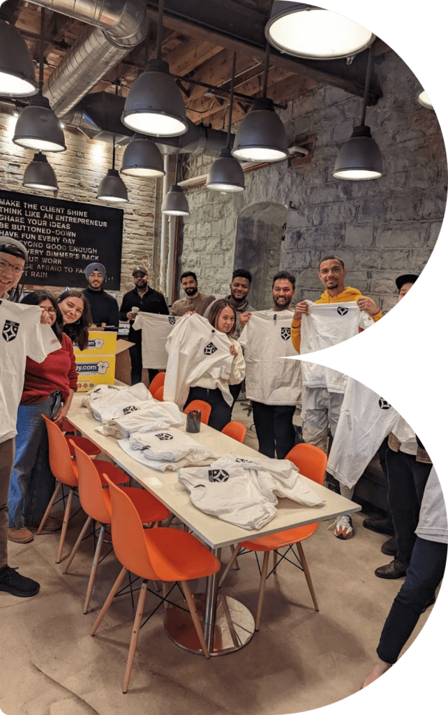 BIMM employees posing with t-shirts at the office.