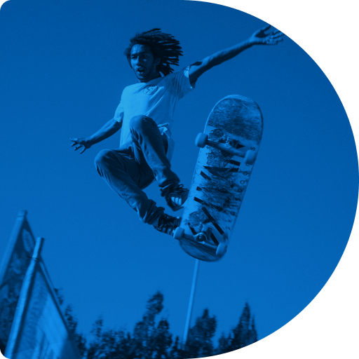 View from below of a skateboarder performing a mid-air trick.